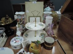 A collection of ceramics amongst which are a floral pattered Falcon Ware cake stand, condiment jar