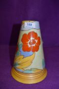 An art deco Shelley vase having bright orange Hibiscus like pattern with blue accents on mint