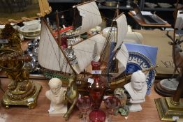 A selection of trinkets including heavy cast horse figure and etched cranberry decanter and glasses