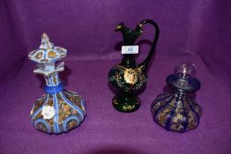A selection of antique hand painted glass wares including coloured and cut squat bottle having