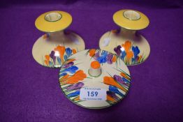Thee item of Bizarre, Crocus by Clarice Cliff Newport potteries,A pair of candlestick holders and