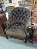 A 19th Century button back easy chair having worn leather on mahogany frame, good solid frame for