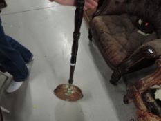 A traditional copper and brass warming pan