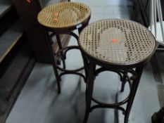A pair of vintage bentwood cane seated bar stools