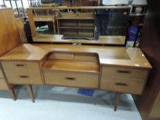 A vintage teak effect dressing table, similar to G plan, matches lots 696, 698 and 699