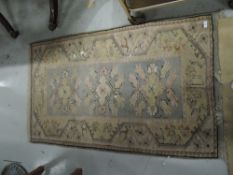 A small fire side rug in pastel colours