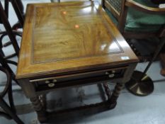 A modern hardwood coffee table having frieze drawer