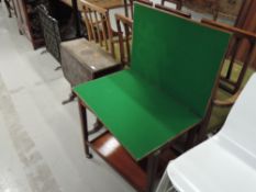 A vintage mahogany tea trolley, having fold out card table top