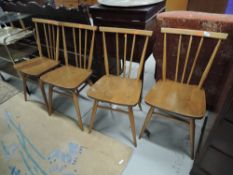A set of four Ercol spindle back kitchen chairs, in mid stain