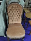 A Victorian button back low seat chair with dralon upholstery on knurl frame