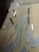 An interesting vintage glass topped coffee table on four wooden legs of cylindrical form, approx. 76