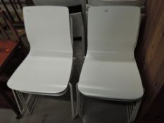 A set of 8 vintage style ply chairs on metal frames in white