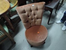 A vintage pink dralon low seat nursing chair having button back