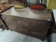 A period oak panelled coffer/kist having carved panel decoration, bearing date 1712, drawer base