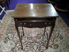 An early 20th Century mahogany side table with fitted compartmental frieze drawer, cross stretcher