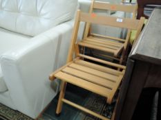 A pair of modern folding chairs