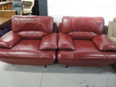 A pair of vintage style red leather armchairs and matching footstool, on chrome legs