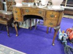 An early to mid 20th reproduction walnut dressing table, of kidney shape