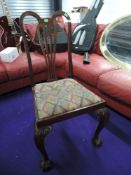 A mahogany dining chair with ball and claw feet