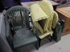 A selection of green plastic garden chairs and complementary cushions
