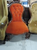A 19th Century mahogany framed button back low seat nursing or work chair, having turned frame and