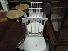 A set of three vintage painted kitchen chairs having rail and stick backs, in the Ercol style