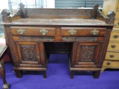 A part 18th Century composite dressing table/sideboard, panelled sides and Victorian gothic ledge
