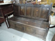 A traditional box settle, constructed from composite oak panels, back panel bearing date 1680,