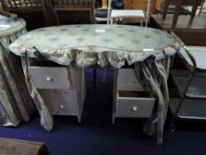 A pair of vintage kidney shaped dressing tables, with glass tops and curtain style decoration
