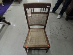 A Victorian bedroom chair having cane seat and back