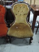 A 19th Century mahogany framed button back low seat nursing or work chair, having knurl frame and