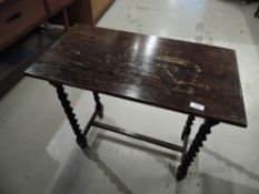 An early 20th Century oak occasional table having barley twist frame