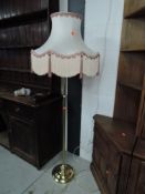 A modern brass standard lamp