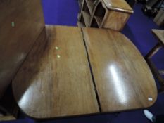 A light stained mahogany winding dining table with leaf