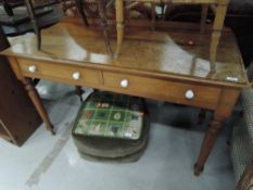 A traditional pine side table having ledge back, turned legs and ceramic drawer handles to the two