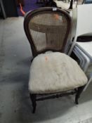 A Victorian mahogany dining chair having stuffed seat and bergere back (needs attention)