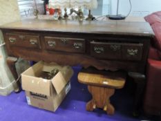 A period oak dresser base, having triple frieze drawers over apron skirting, on cabriole legs, width