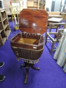 A 19th Century walnut sewing table on turned pedestal base with triple splay legs with brass inlay