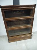 An early 20th Century oak three tier stacking bookcase, bearing labels for Globe-Wernicke