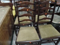 A set of four vintage stained frame ladder back chairs