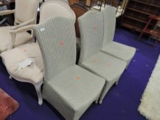 A set four modern Lloyd Loom style dining or conservatory chairs