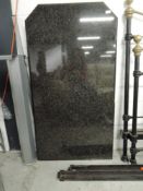 A modern granite breakfast bar and two modern stools