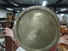 A large circular brass tray, probably indian, diameter approx. 60cm