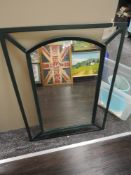A metal framed arched mirror