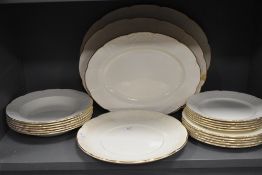 An assortment of Wedgewood plates, graded platters and bowls having basket weave type raised pattern