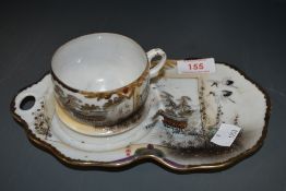 A Chinese eggshell tennis set or tea cup and saucer decorated with stalks and river scene