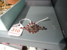 A garnet and seed pearl bar brooch in yellow metal mount stamped 9ct (af)