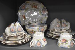 A collection of cups and saucers,side plates,cake plate,basin and jug, having transfer pattern