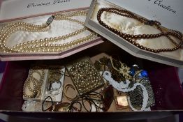 A small selection of costume jewellery including cased simulated pearls, glass pendants, Indian coin