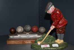 A golfing interest cast door stop and a gold ball ornament.